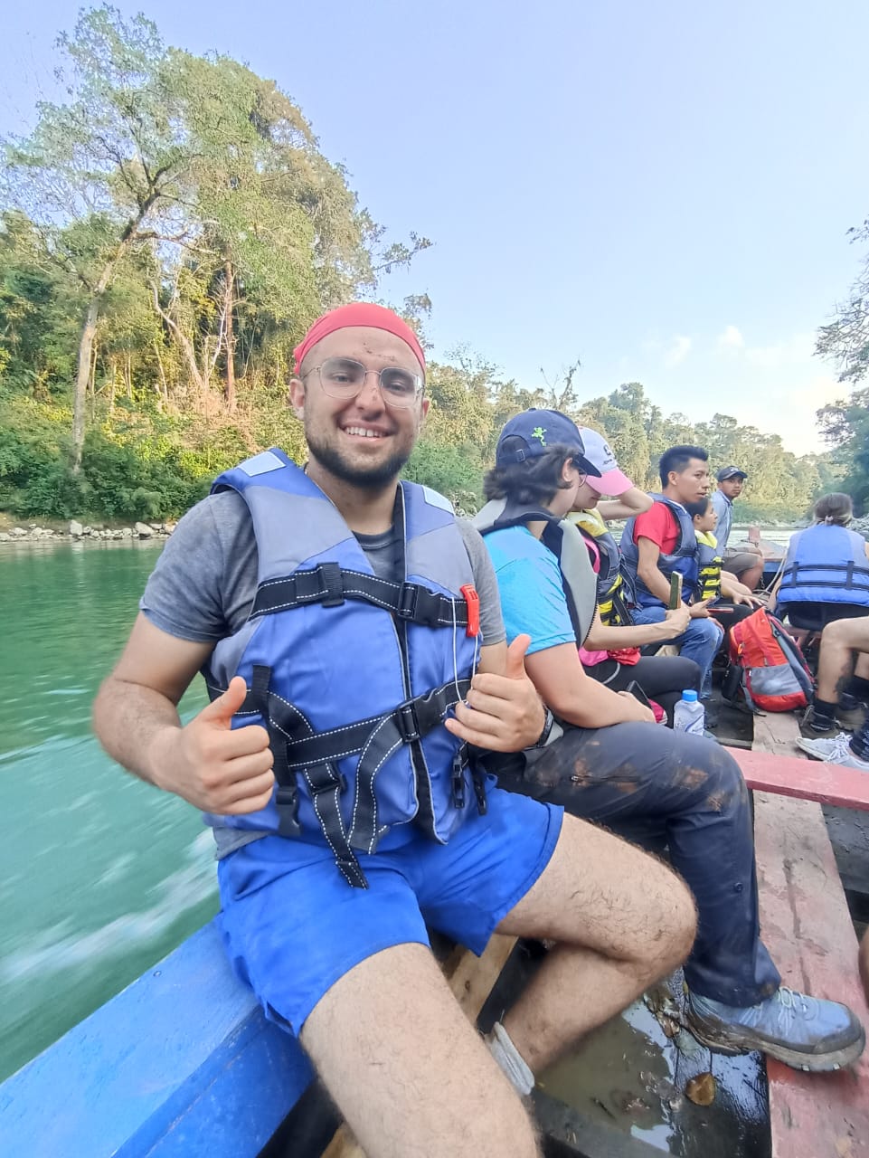 Matteo Arellano travelling by boat with a community group on a river in Guatemala